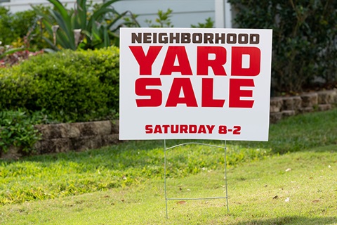 yard sale sign in someone's yard